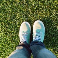 Someone Standing in the Yard on Green Grass